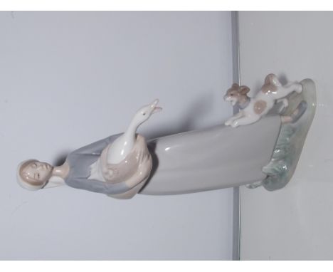 A Lladro figure of a girl with a goose and dog 27cm high