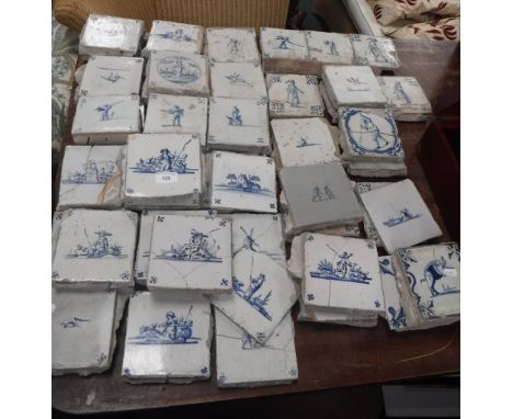 A LARGE COLLECTION OF DELFTWARE TILES, with blue and white painted landscapes, figures and animals