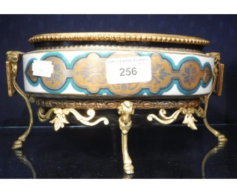 A CERAMIC VASE on gilt metal stand
