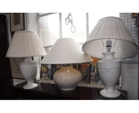 A PAIR OF CREAM CERAMIC TABLE LAMPS, pleated shades and a crackle glaze ceramic table lamp