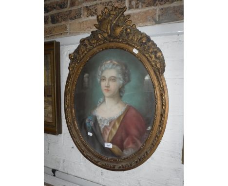 AN 18TH CENTURY STYLE PASTEL PORTRAIT OF A LADY in an oval gilt frame with musical trophy surmount