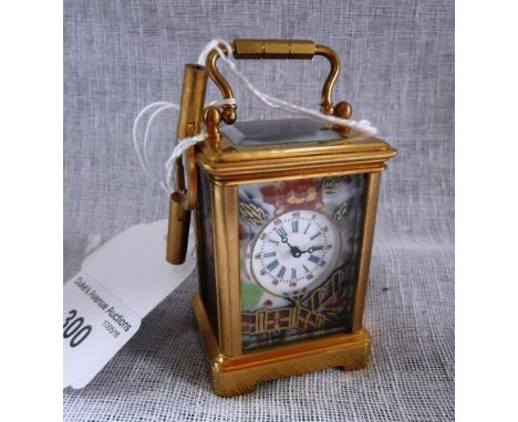 A MINIATURE BRASS CARRIAGE CLOCK with inset ceramic panels