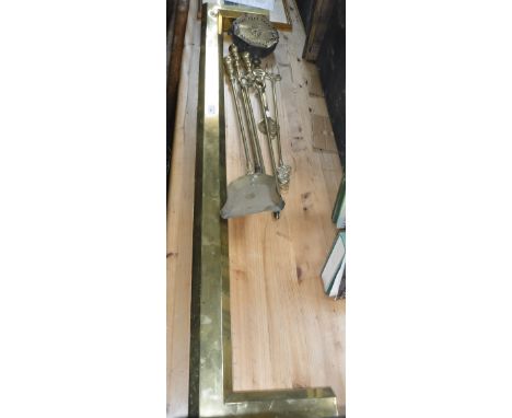 A SET OF THREE 19TH CENTURY BRASS FIRE TOOLS, a brass fender and similar items