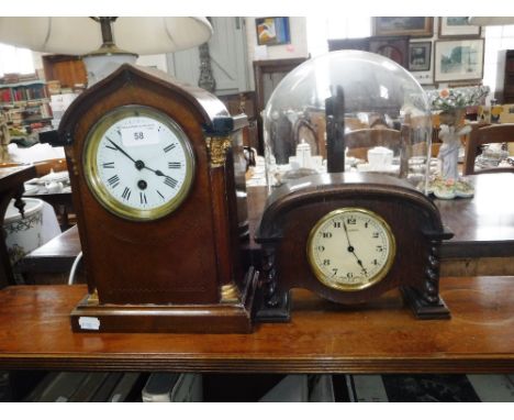AN EDWARDIAN MAHOGANY CASED MANTEL CLOCK and a 1920's oak-cased clock
