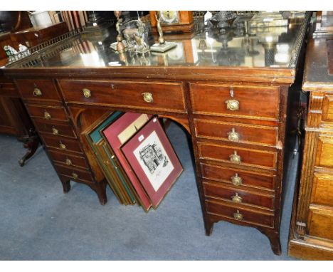 A GEORGE III STYLE DRESSING TABLE with inset mirrored top and brass gallery on swept bracket feet, 50" wide