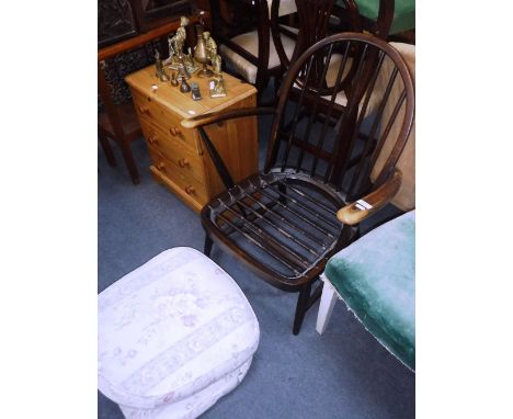 AN ERCOL ARMCHAIR and a small pine chest of three drawers