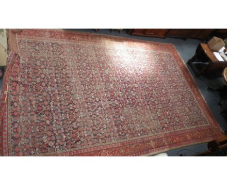 A LARGE BLUE GROUND PERSIAN CARPET with overall geometric decoration, 195" X 125"