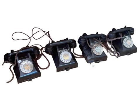 Four vintage dial telephones.
