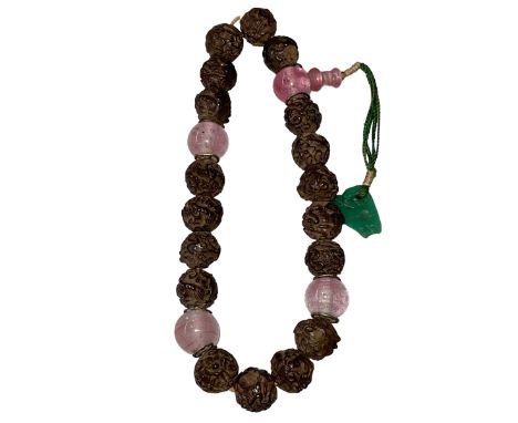 Chinese aloeswood rosary consisting of beads and a jade pendant.