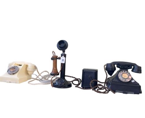 Vintage stick telephone and two vintage dial telephones.