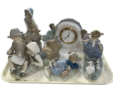 Four pieces of Lladro including Two Sisters Clock and Hurry Now, and Nao boy and girl group (3).