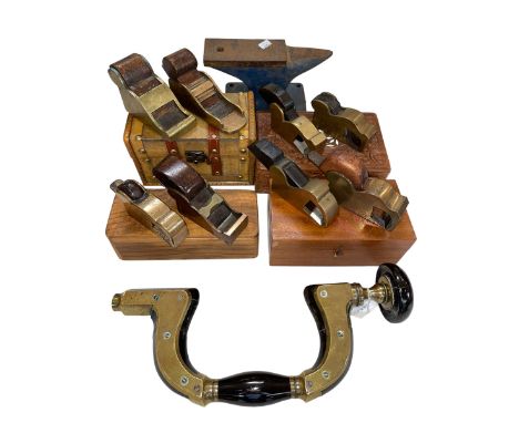 Vintage tools including James Howarth brace, small brass planes and small anvil.