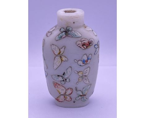 A hand painted milk glass and enamel decorated bottle with butterfly decoration hand painted blue 3 character mark to base . 