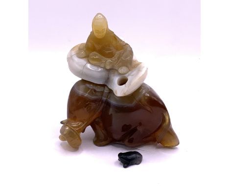 A large Chinese carved banded agate snuff bottle in the form of a Guanyin astride and Elephant, the stopper being a small car