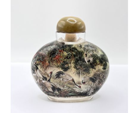 A very finely inside painted table snuff bottle depicting cranes feeding, H.9cm x W.8.5cm. Red signature panel Attributed to 