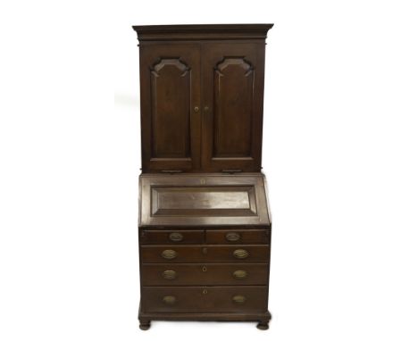 An 18thC and later walnut cabinet bookcase, with moulded cornice over two shaped and fielded panelled doors revealing pigeonh