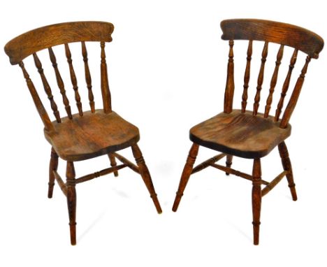 A pair of ash and elm apprentice piece dining chairs, each with comb and spindle backs, shaped seats and triple ring turned f