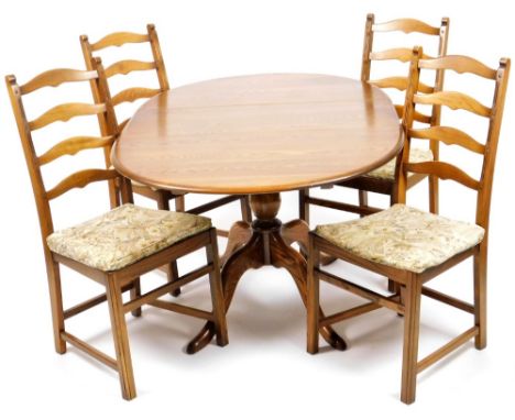 An Ercol dining suite, comprising of an extending dining table, the oval top on baluster stem terminating in quadruple legs, 