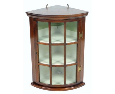 A 20thC mahogany hanging corner cabinet, with astragal glazed door, 67cm H, 52cm W, 36cm D.