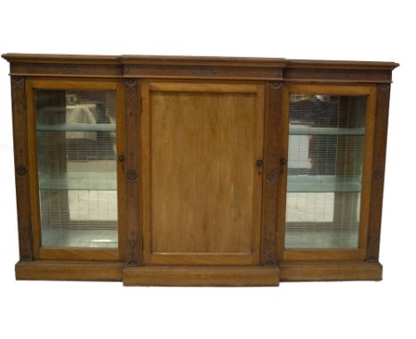 A late Victorian satinwood and walnut breakfront side cabinet, with aesthetic scratch carved roundel and foliate decoration t