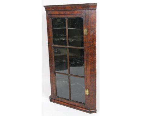 An 18thC country hanging corner cabinet, with glass panel door, reveal shaped shelves and H-hinges, 70cm W.