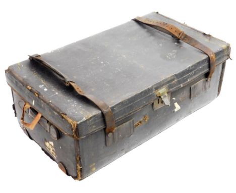 An early 20thC pressed leather travel trunk, with metal locks, 85cm W, and a further travel case.