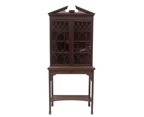 A late Victorian Chinese Chippendale revival display cabinet on stand, with dentil moulded and fretwork broken arch pediment,