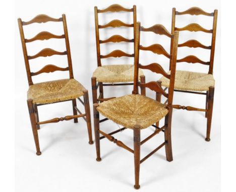 A set of four 19thC elm rush seated chairs, each with ladder backs, on turned front legs, joined by double turned stretchers,
