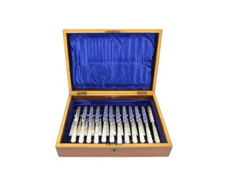 Edwardian part canteen of cutlery, set of twelve dessert knives and eleven forks, with mother of pearl handles, all with silv