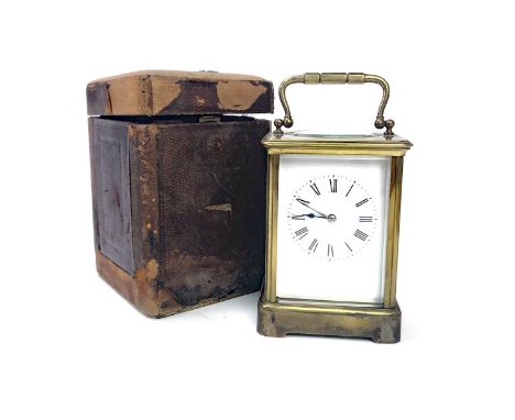 EARLY 20TH CENTURY BRASS CARRIAGE CLOCK, French movement, the white enamel dial with Roman numerals, contained in a bevelled 