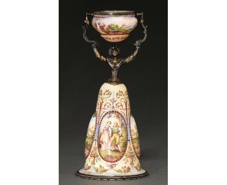 A Viennese silver gilt and painted enamel wager cup, early 20th c, in the form of a woman, her skirts with raised medallions 