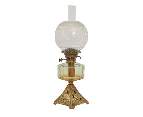 A Victorian oil lamp, with gilded iron base, green glass fount and etched globular glass shade, 58cm h Good condition