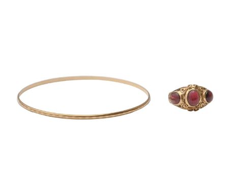 A garnet cabochon ring, in 9ct gold, Birmingham 1974, size O and a gold bangle marked 375, 8.3g (2) Ring slightly worn