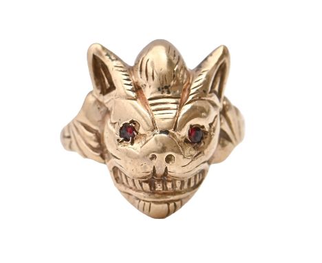 A 9ct gold demon mask ring, with red stone eyes, Birmingham 1984, 10.8g, size I Light wear