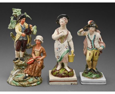 Two Staffordshire pearl ware figures of a youth and girl and a contemporary group of musicians, c1820-30, painted in overglaz