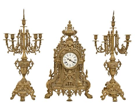 An Italian pierced brass clock garniture, in Louis XVI style, the enamel dial indistinctly signed, clock 59 x 37.5cm, candela
