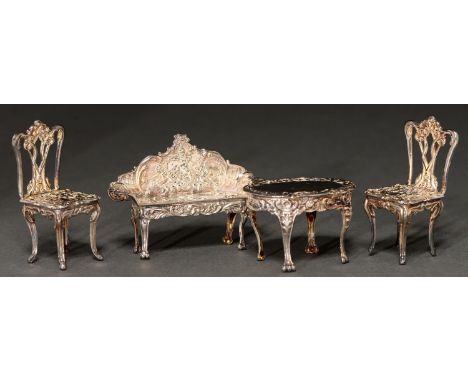 An Elizabeth II suite of silver toys, comprising sofa, pair of chairs and table, sofa 65mm l, by David Hollander &amp; Son, B