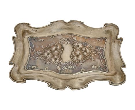 An Edwardian Art Nouveau silver dressing table tray, die stamped with flowers, 29.5cm l, by William Neale Ltd, Chester 1903, 