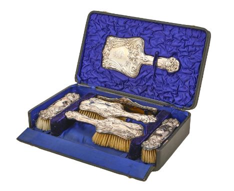 An Edwardian Art Nouveau six piece silver brush set, by Harry Hayes, Birmingham 1904, cased Good condition. Case lacking one 