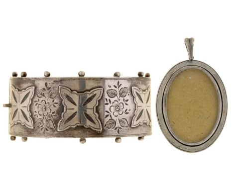 A Victorian silver bangle, with engraved and applied decoration, 55mm (internal), Birmingham 1885, 31g and a silver locket, d