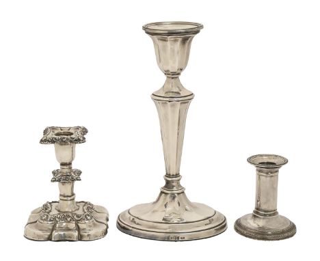 An Elizabeth II silver candlestick,&nbsp; of fluted oval form, nozzle, 26cm h, by Carr's of Sheffield, 1997 and two smaller s