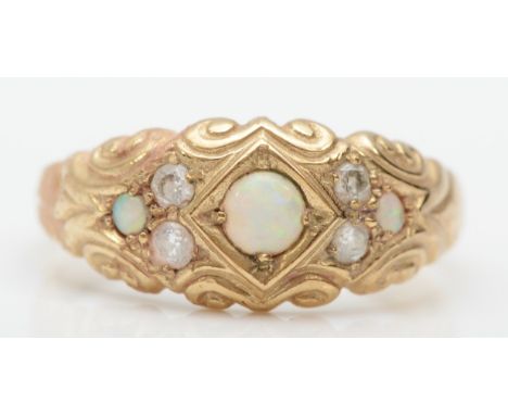 A 9ct gold opal and diamond dress ring with scroll decorated setting, R, 3gm.'Condition report - The middle stone is missing 