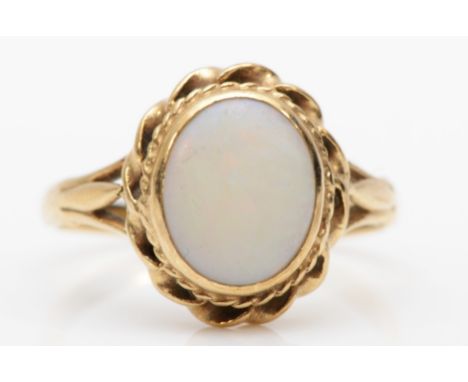 An unmarked gold opal dress ring, O, 2.9gm.Condition report - stone is heavily scratched. 