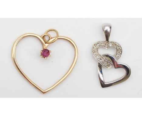 A 9ct white gold diamond heart shaped pendant, 20 x 10mm, with a 9ct gold ruby heart shaped pendant, 2.4gm. 