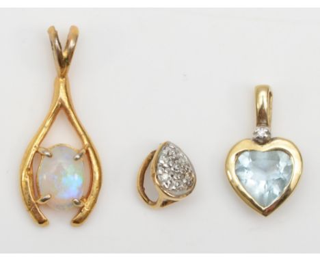 A 9ct gold topaz and diamond heart shaped pendant, 14 x 8mm, together with two unmarked gold opal and diamond pendants, 1.9gm