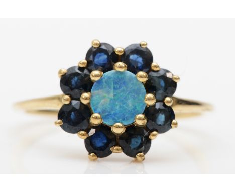 A 9ct gold opal doublet and sapphire cluster ring, L-M, 1.8gm.Condition report - The middle opal has a chip with cracks sprea