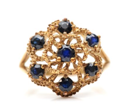 A 9ct gold sapphire floral dress ring, O-P, 3.9gm. Condition report -&nbsp;The ring setting has slight fire scale to the claw