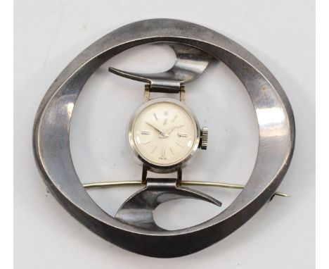 A ladies stainless steel manual wind watch, mounted in an abstract brooch, 52 x 48mm overall, working when catalogued 