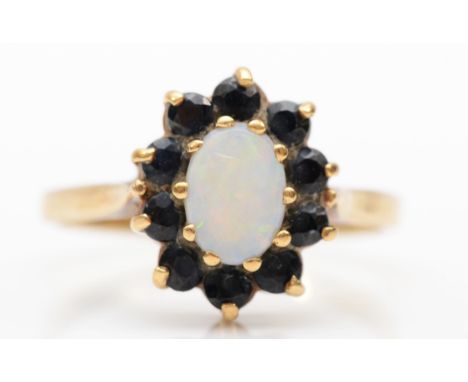 A 9ct gold opal and sapphire cluster ring, O, 2.4gm.Condition report - The opal top is scratched, fire scale to the shoulders