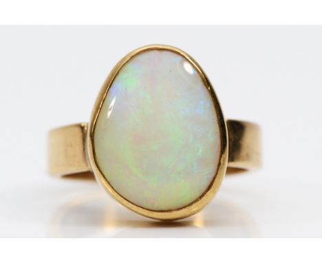 A 9ct gold free form opal dress ring, flashes of green, orange, blue, L, 3.9gm. 